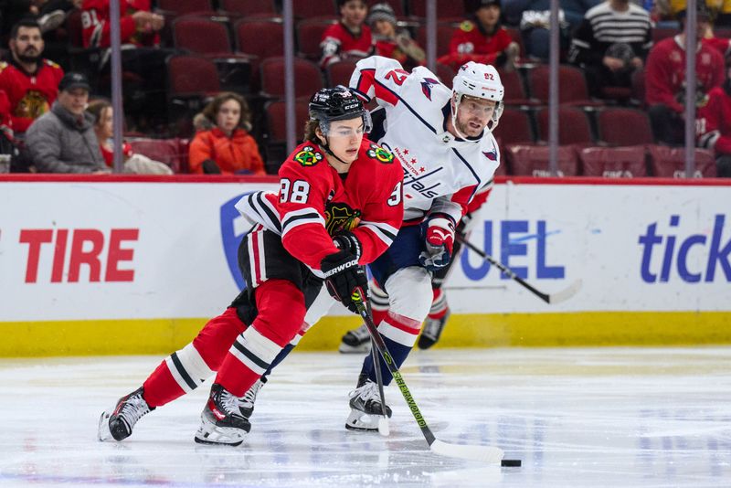 Dec 10, 2023; Chicago, Illinois, USA; Chicago Blackhawks center Connor Bedard (98) plays the puck as Washington Capitals center Evgeny Kuznetsov (92) defends during the second period at the United Center. Mandatory Credit: Daniel Bartel-USA TODAY Sports