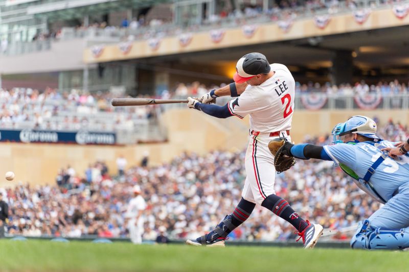 May 24, 2025; Minneapolis, Minnesota, USA; Minnesota Twins shortstop Brooks Lee (2) hits the game winning single that would score Minnesota Twins shortstop Carlos Correa (not shown) against Kansas City Royals pitcher Steven Cruz (not shown) in the ninth inning at Target Field. Mandatory Credit: Matt Blewett-Imagn Images