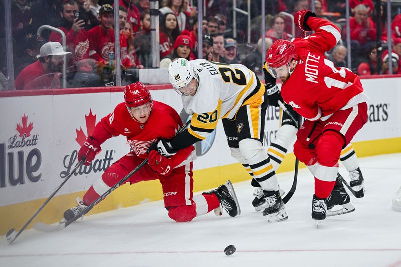 Oct 10, 2024; Detroit, Michigan, USA; Pittsburgh Penguins center Lars Eller (20) battles for the puck against Detroit Red Wings right wing Jonatan Berggren (48) and center Tyler Motte (14) during the game at Little Caesars Arena. Mandatory Credit: Tim Fuller-Imagn Images