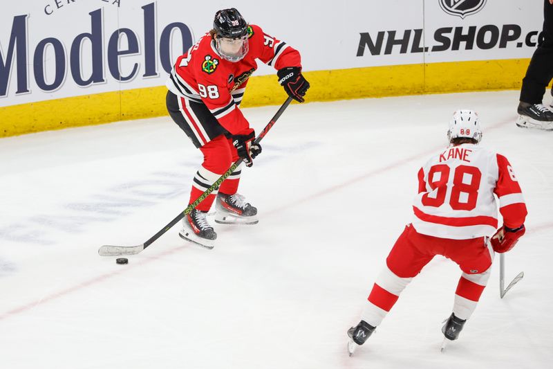 Feb 25, 2024; Chicago, Illinois, USA; Chicago Blackhawks center Connor Bedard (98) looks to pass the puck against Detroit Red Wings right wing Patrick Kane (88) during the second period at United Center. Mandatory Credit: Kamil Krzaczynski-USA TODAY Sports