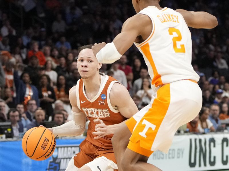 March 23, 2024, Charlotte, NC, USA; Texas Longhorns guard Chendall Weaver (2) drives against Tennessee Volunteers guard Jordan Gainey (2) in the second round of the 2024 NCAA Tournament at the Spectrum Center. Mandatory Credit: Bob Donnan-USA TODAY Sports