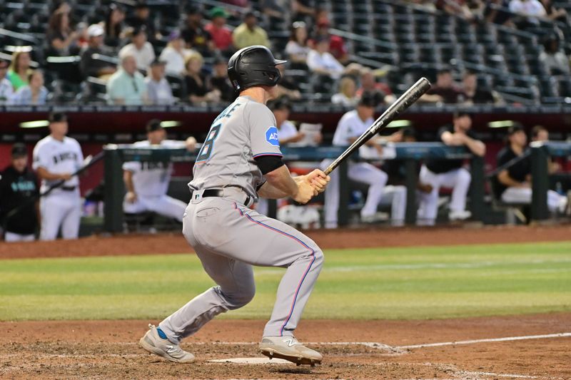 May 10, 2023; Phoenix, Arizona, USA; Miami Marlins shortstop Joey Wendle (18) hits an RBI double in the ninth inning against the Arizona Diamondbacks at Chase Field. Mandatory Credit: Matt Kartozian-USA TODAY Sports