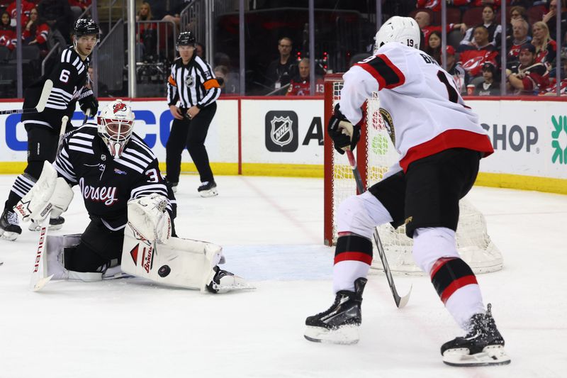 Mar 23, 2024; Newark, New Jersey, USA; New Jersey Devils goaltender Jake Allen (34) makes a save against the Ottawa Senators during the third period at Prudential Center. Mandatory Credit: Ed Mulholland-USA TODAY Sports