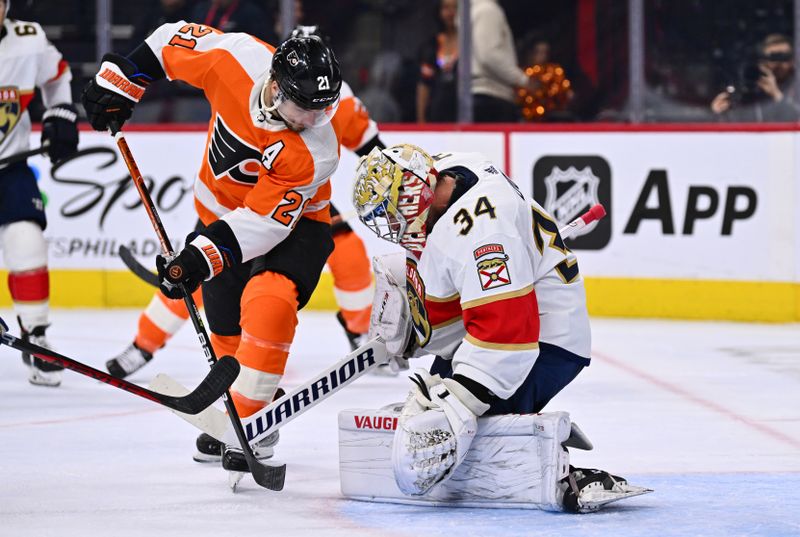 Mar 21, 2023; Philadelphia, Pennsylvania, USA; Philadelphia Flyers center Scott Laughton (21) reaches in against Florida Panthers goalie Alex Lyon (34) in the first period at Wells Fargo Center. Mandatory Credit: Kyle Ross-USA TODAY Sports