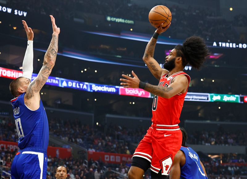 LOS ANGELES, CALIFORNIA - MARCH 09:  Coby White #0 of the Chicago Bulls takes a shot against Daniel Theis #10 of the LA Clippers in the first half at Crypto.com Arena on March 09, 2024 in Los Angeles, California.  NOTE TO USER: User expressly acknowledges and agrees that, by downloading and/or using this photograph, user is consenting to the terms and conditions of the Getty Images License Agreement.  (Photo by Ronald Martinez/Getty Images)