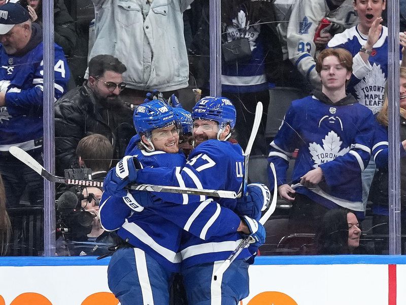 Feb 15, 2024; Toronto, Ontario, CAN; Toronto Maple Leafs right wing William Nylander (88) scores the winning goal and celebrates with  defenseman Timothy Liljegren (37) against the Philadelphia Flyers during the overtime period at Scotiabank Arena. Mandatory Credit: Nick Turchiaro-USA TODAY Sports