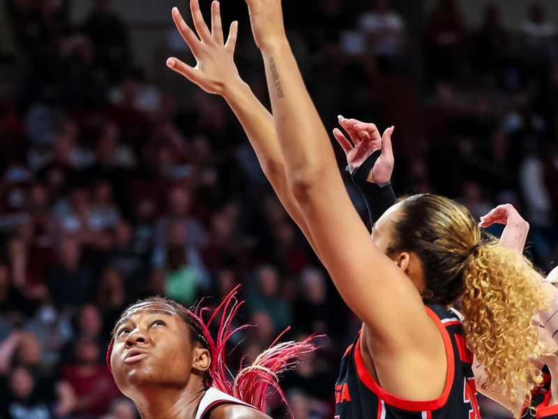 Feb 26, 2023; Columbia, South Carolina, USA; South Carolina Gamecocks forward Aliyah Boston (4) looks to shoot over Georgia Lady Bulldogs guard Audrey Warren (31) in the first half at Colonial Life Arena. Mandatory Credit: Jeff Blake-USA TODAY Sports