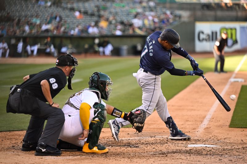 Sep 2, 2024; Oakland, California, USA; Seattle Mariners second base Jorge Polanco (7) hits against the Oakland Athletics in the sixth inning at Oakland-Alameda County Coliseum. Mandatory Credit: Eakin Howard-USA TODAY Sports