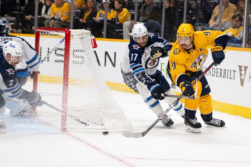 Nov 23, 2024; Nashville, Tennessee, USA;  Winnipeg Jets defenseman Dylan DeMelo (2) blocks the shot of Nashville Predators left wing Filip Forsberg (9) during the third period at Bridgestone Arena. Mandatory Credit: Steve Roberts-Imagn Images