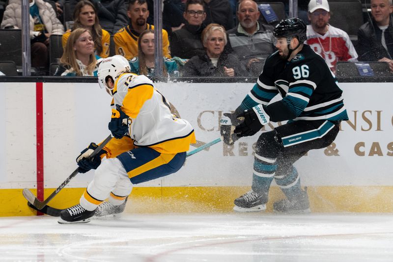 Jan 23, 2025; San Jose, California, USA;  Nashville Predators center Vinnie Hinostroza (12) and San Jose Sharks defenseman Jake Walman (96) battle for the puck against the boards during the first period at SAP Center at San Jose. Mandatory Credit: Neville E. Guard-Imagn Images