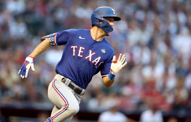 Oct 30, 2023; Phoenix, AZ, USA; Texas Rangers center fielder Evan Carter (32) singles during the second inning in game three of the 2023 World Series against the Arizona Diamondbacks at Chase Field. Mandatory Credit: Mark J. Rebilas-USA TODAY Sports