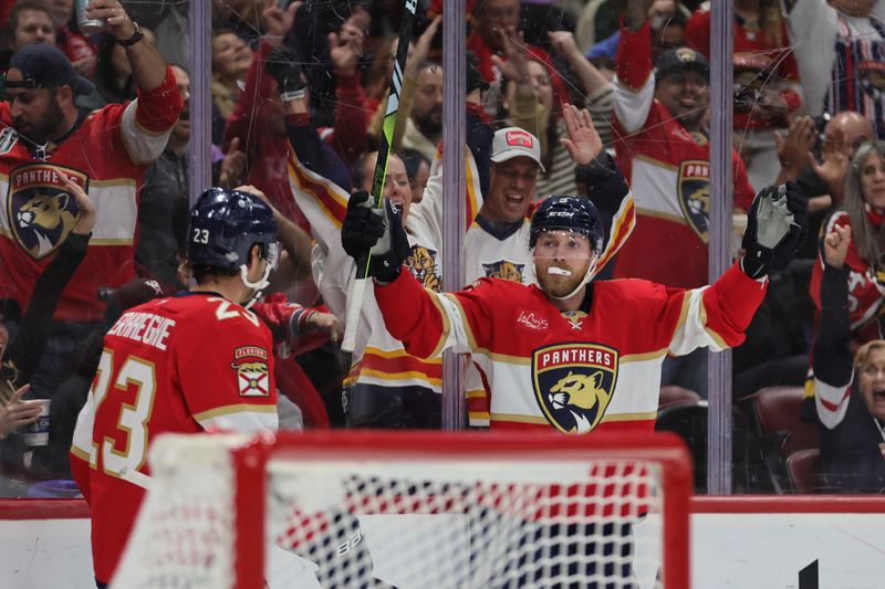 Oct 22, 2024; Sunrise, Florida, USA; Florida Panthers center Sam Bennett (9) celebrates with center Sam Reinhart (13) after scoring against the Minnesota Wild during the second period at Amerant Bank Arena. Mandatory Credit: Sam Navarro-Imagn Images