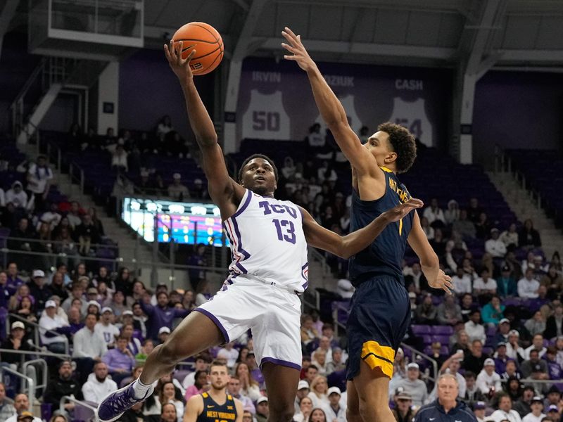 Jan 31, 2023; Fort Worth, Texas, USA; TCU Horned Frogs guard Shahada Wells (13) scores a layup against West Virginia Mountaineers forward Emmitt Matthews Jr. (1) during the first half at Ed and Rae Schollmaier Arena. Mandatory Credit: Chris Jones-USA TODAY Sports