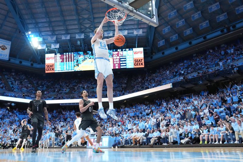 Feb 28, 2026; Chapel Hill, North Carolina, USA; North Carolina Tar Heels center Henri Veesaar (13) scores as Virginia Tech Hokies forward Tobi Lawal (1) and guard Jailen Bedford (0) defend in the second half at Dean E. Smith Center. Mandatory Credit: Bob Donnan-Imagn Images