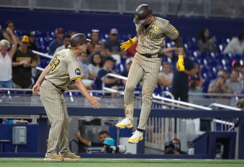 Aug 9, 2024; Miami, Florida, USA;  San Diego Padres center fielder Jackson Merrill (3) celebrates his home run with third base coach Tim Leiper (33) against the Miami Marlins in the ninth inning at loanDepot Park. Mandatory Credit: Rhona Wise-USA TODAY Sports