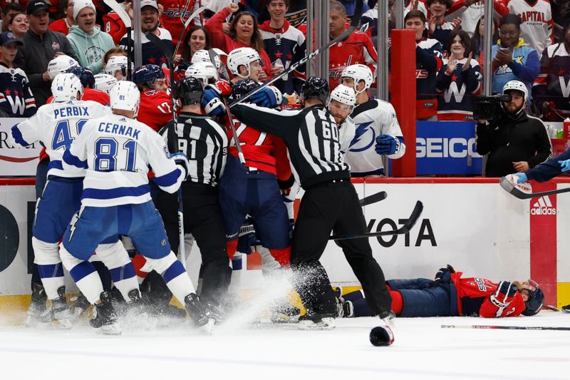 Apr 13, 2024; Washington, District of Columbia, USA; Washington Capitals and Tampa Bay Lightning players scrum after a hit by Lightning center Michael Eyssimont (23) that injured Capitals defenseman Nick Jensen (3) in the first period at Capital One Arena. Mandatory Credit: Geoff Burke-USA TODAY Sports