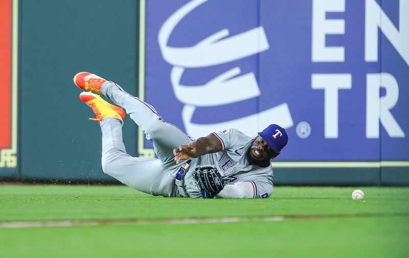 Apr 14, 2024; Houston, Texas, USA; Texas Rangers right fielder Adolis Garcia (53) is unable to make a catch on a fly ball by Houston Astros third baseman Mauricio Dubon (not pictured) during the fourth inning at Minute Maid Park. Mandatory Credit: Troy Taormina-USA TODAY Sports
