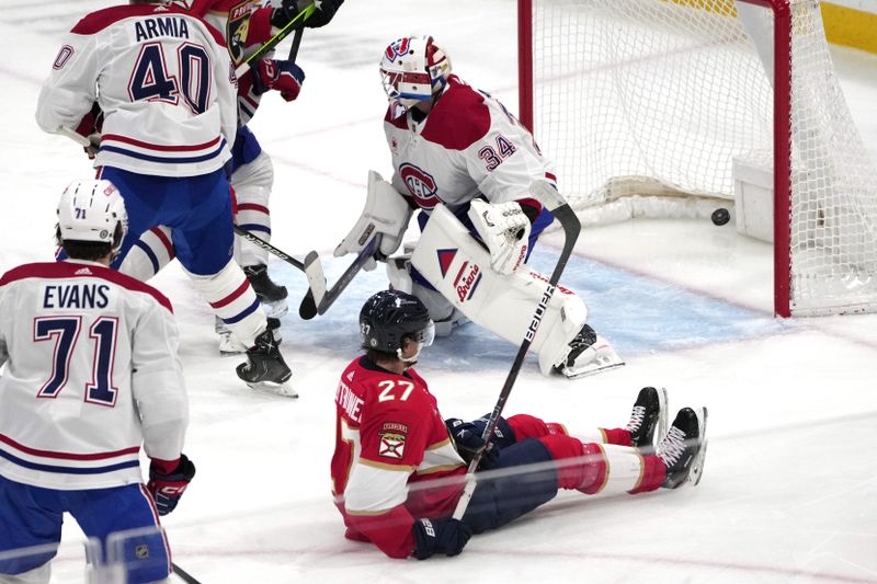 Dec 30, 2023; Sunrise, Florida, USA;  Florida Panthers center Eetu Luostarinen (27) scores a goal past Montreal Canadiens goaltender Jake Allen (34) during the second period at Amerant Bank Arena. Mandatory Credit: Jim Rassol-USA TODAY Sports