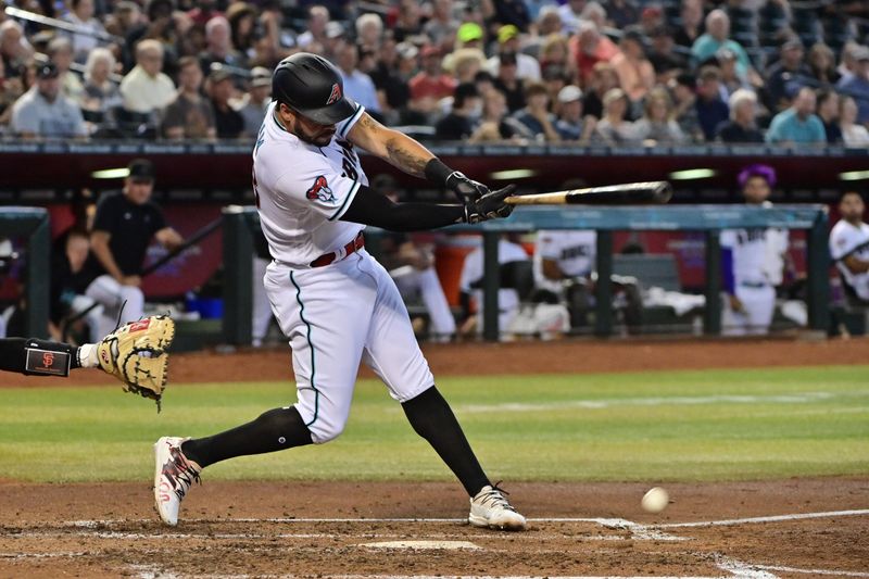 Sep 20, 2023; Phoenix, Arizona, USA;  Arizona Diamondbacks left fielder Tommy Pham (28) hits an RBI single in the third inning against the San Francisco Giants at Chase Field. Mandatory Credit: Matt Kartozian-USA TODAY Sports