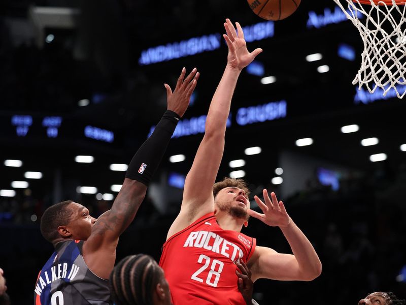 NEW YORK, NEW YORK - JANUARY 27:  Alperen Sengun #28 of the Houston Rockets shoots against Lonnie Walker IV #8 of the Brooklyn Nets during their game at Barclays Center on January 27, 2024 in New York City.  User expressly acknowledges and agrees that, by downloading and or using this photograph, User is consenting to the terms and conditions of the Getty Images License Agreement.   (Photo by Al Bello/Getty Images)