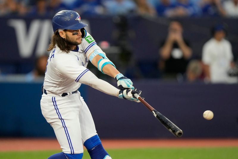 Jul 19, 2023; Toronto, Ontario, CAN; Toronto Blue Jays shortstop Bo Bichette (11) hits a single against the San Diego Padres during the fifth inning at Rogers Centre. Mandatory Credit: John E. Sokolowski-USA TODAY Sports