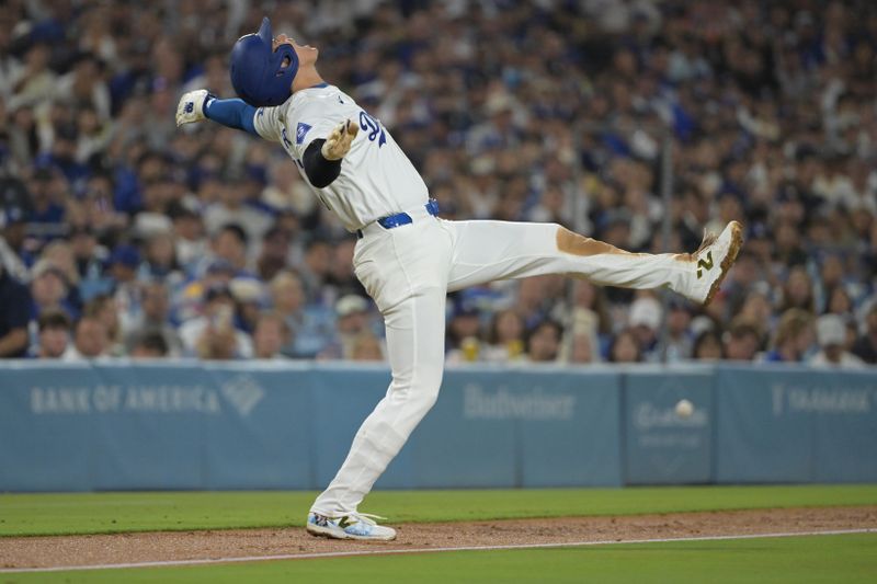 Aug 28, 2024; Los Angeles, California, USA;  Los Angeles Dodgers designated hitter Shohei Ohtani (17) jumps out of the way of a foul ball hit down the third base line by left fielder Teoscar Hernandez (37) in the third inning against the Baltimore Orioles at Dodger Stadium. Mandatory Credit: Jayne Kamin-Oncea-USA TODAY Sports