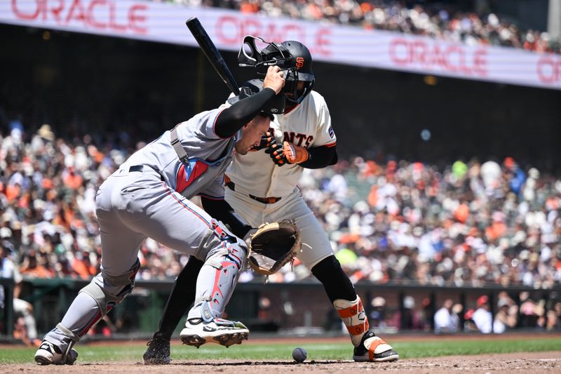 Jun 26, 2025; San Francisco, California, USA; Miami Marlins catcher Nick Fortes (4) chases a wild pitch against San Francisco Giants left fielder Heliot Ramos (17) in the fourth inning at Oracle Park. Mandatory Credit: Eakin Howard-Imagn Images