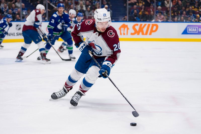 Mar 13, 2024; Vancouver, British Columbia, CAN; Colorado Avalanche forward Ross Colton (20) handles the puck against the Vancouver Canucks in the third period at Rogers Arena. Colorado won 4 -3 in overtime. Mandatory Credit: Bob Frid-USA TODAY Sports