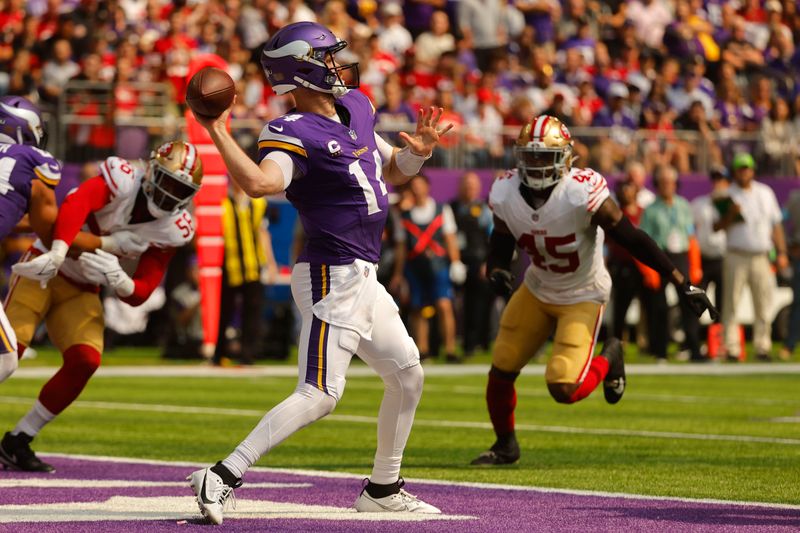 Minnesota Vikings quarterback Sam Darnold (14) throws a 97-yard touchdown pass to wide receiver Justin Jefferson during the first half of an NFL football game against the San Francisco 49ers, Sunday, Sept. 15, 2024, in Minneapolis. (AP Photo/Bruce Kluckhohn)