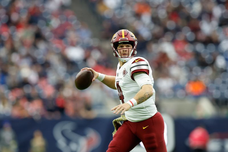 Washington Commanders quarterback Taylor Heinicke (4) looks to pass during an NFL game against the Houston Texans on Sunday, November 20, 2022, in Houston. (AP Photo/Matt Patterson)