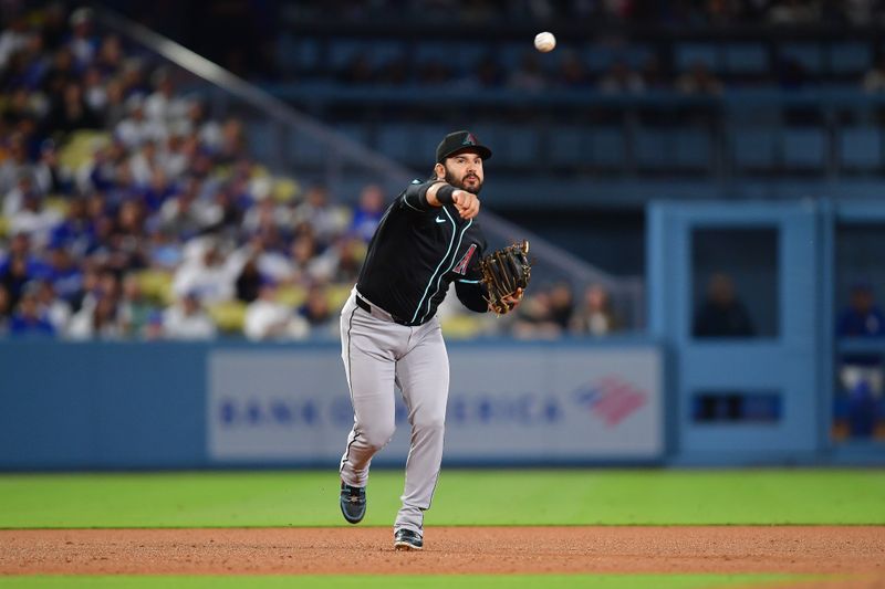 May 19, 2025; Los Angeles, California, USA; Arizona Diamondbacks third baseman Eugenio Suarez (28) throws to first for the out against Los Angeles Dodgers catcher Will Smith (16) during the sixth inning at Dodger Stadium. Mandatory Credit: Gary A. Vasquez-Imagn Images