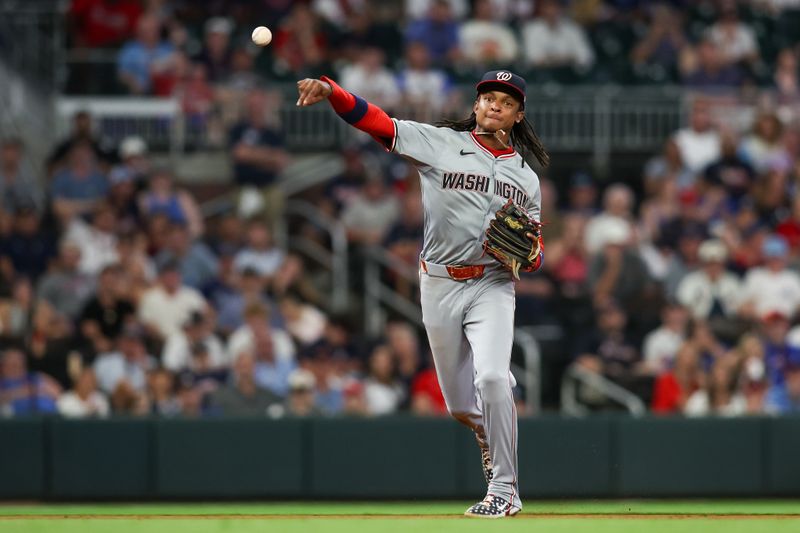 May 28, 2024; Atlanta, Georgia, USA; Washington Nationals shortstop CJ Abrams (5) throws a runner out at first against the Atlanta Braves in the eighth inning at Truist Park. Mandatory Credit: Brett Davis-USA TODAY Sports