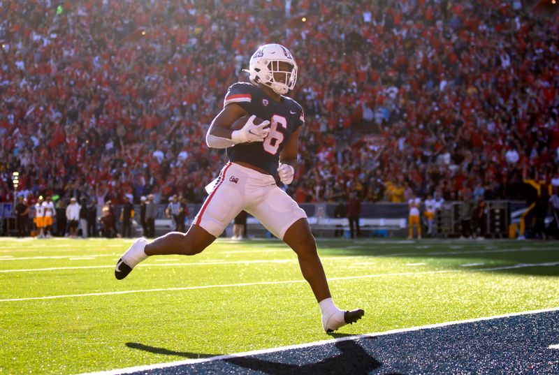 Nov 25, 2022; Tucson, Arizona, USA; Arizona Wildcats running back Michael Wiley (6) runs for a touchdown against the Arizona State Sun Devils in the second half of the Territorial Cup at Arizona Stadium. Mandatory Credit: Mark J. Rebilas-USA TODAY Sports