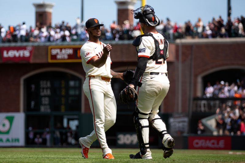 Jun 8, 2025; San Francisco, California, USA; San Francisco Giants pitcher Camilo Doval (75) and catcher Andrew Knizner (21) celebrate their 4-3 victory over the Atlanta Braves at Oracle Park. Mandatory Credit: D. Ross Cameron-Imagn Images