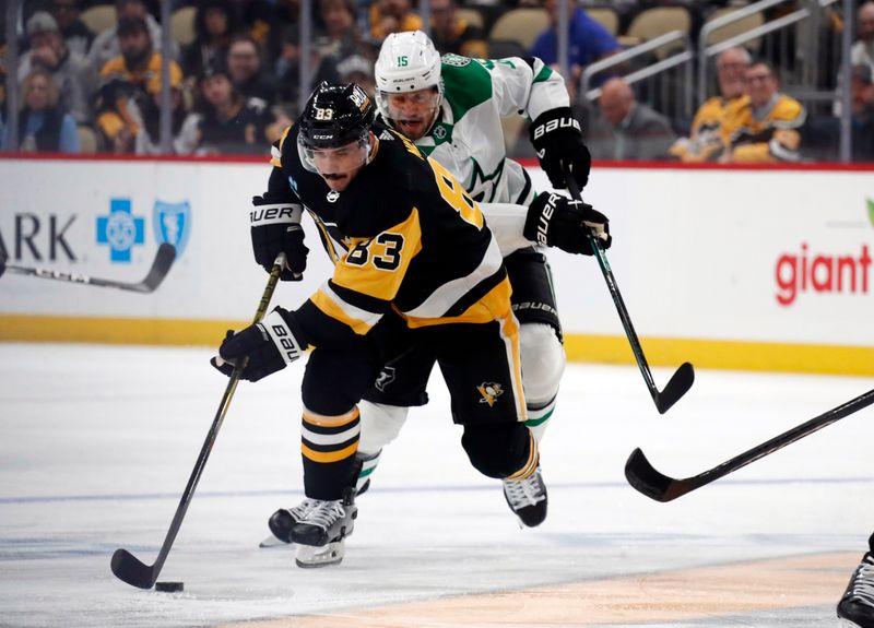 Oct 24, 2023; Pittsburgh, Pennsylvania, USA; Pittsburgh Penguins left wing Matt Nieto (83) moves the puck ahead of Dallas Stars center Craig Smith (15) during the first period at PPG Paints Arena. Mandatory Credit: Charles LeClaire-USA TODAY Sports