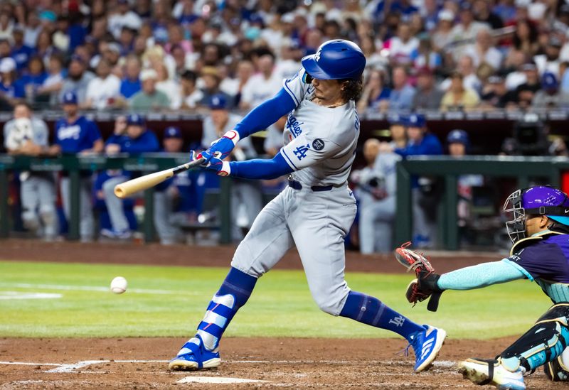 May 9, 2025; Phoenix, Arizona, USA; Los Angeles Dodgers outfielder James Outman drives in two runs in the third with a fielders choice against the Arizona Diamondbacks at Chase Field. Mandatory Credit: Mark J. Rebilas-Imagn Images