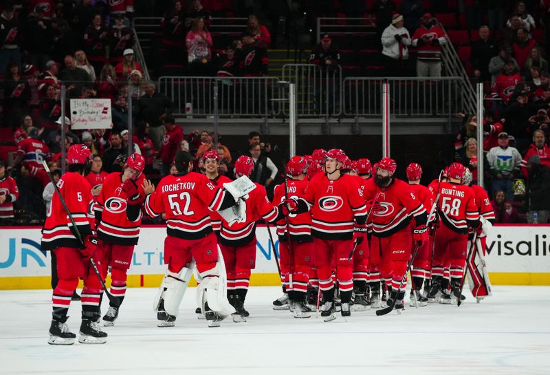 Dec 28, 2023; Raleigh, North Carolina, USA; Carolina Hurricanes players celebrate their victory against the Montreal Canadiens at PNC Arena. Mandatory Credit: James Guillory-USA TODAY Sports