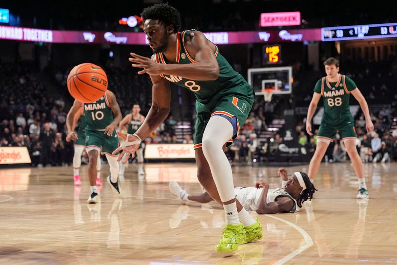 Jan 7, 2026; Winston-Salem, North Carolina, USA; Miami (FL) Hurricanes center Ernest Udeh Jr. (8) grabs the rebound during the second half against the Wake Forest Demon Deacons at Lawrence Joel Veterans Memorial Coliseum. Mandatory Credit: Jim Dedmon-Imagn Images