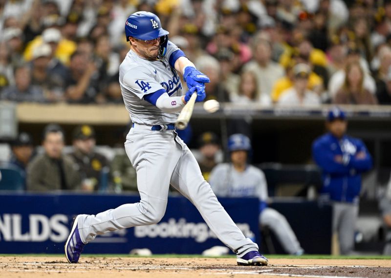 Oct 9, 2024; San Diego, California, USA; Los Angeles Dodgers third baseman Enrique Hernandez (8) singles in the second inning against the San Diego Padres during game four of the NLDS for the 2024 MLB Playoffs at Petco Park.  Mandatory Credit: Denis Poroy-Imagn Images