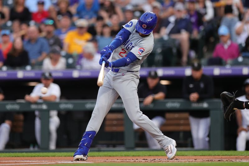 Sep 13, 2024; Denver, Colorado, USA; Chicago Cubs right fielder Cody Bellinger (24) hits a two RBI single in the first inning against the Colorado Rockies at Coors Field. Mandatory Credit: Isaiah J. Downing-Imagn Images