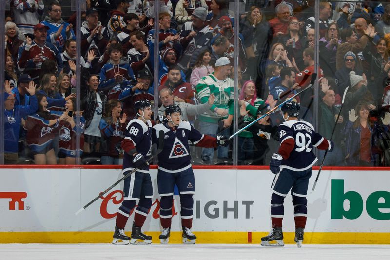 Dec 31, 2025; Denver, Colorado, USA; Colorado Avalanche center Nathan MacKinnon (29) celebrates his goal with center Martin Necas (88) and left wing Gabriel Landeskog (92) in the first period against the St. Louis Blues at Ball Arena. Mandatory Credit: Isaiah J. Downing-Imagn Images
