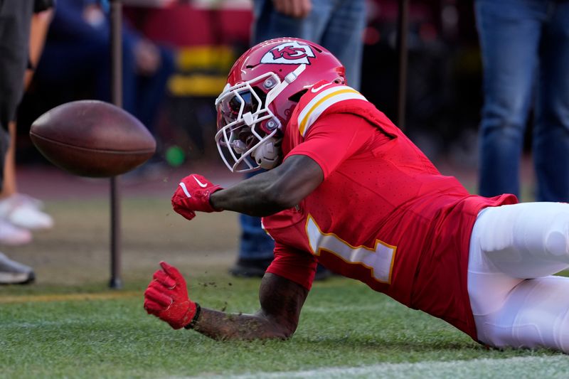 Kansas City Chiefs wide receiver Xavier Worthy (1) is unable to catch a pass during the second half of an NFL football game against the Denver Broncos Sunday, Nov. 10, 2024, in Kansas City, Mo. (AP Photo/Ed Zurga)