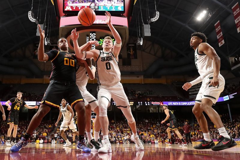 Dec 4, 2024; Minneapolis, Minnesota, USA; Michigan State Spartans forward Jaxon Kohler (0) and Minnesota Golden Gophers forward Frank Mitchell (00) compete for the ball during the first half at Williams Arena. Mandatory Credit: Matt Krohn-Imagn Images