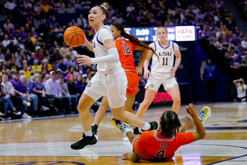 Feb 22, 2024; Baton Rouge, Louisiana, USA; LSU Lady Tigers guard Last-Tear Poa (13) knocks down Auburn Tigers guard Kaitlyn Duhon (4) on her way to the basket during the first half at Pete Maravich Assembly Center. Mandatory Credit: Matthew Hinton-USA TODAY Sports