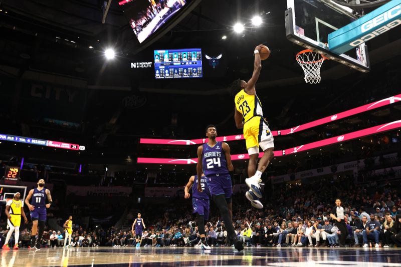 CHARLOTTE, NORTH CAROLINA - FEBRUARY 12: Aaron Nesmith #23 of the Indiana Pacers dunks the ball on a fast break during the second half of an NBA game against the Charlotte Hornets at Spectrum Center on February 12, 2024 in Charlotte, North Carolina. NOTE TO USER: User expressly acknowledges and agrees that, by downloading and or using this photograph, User is consenting to the terms and conditions of the Getty Images License Agreement. (Photo by David Jensen/Getty Images)