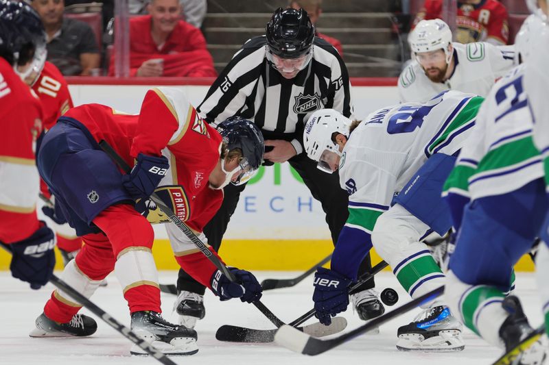 Oct 17, 2024; Sunrise, Florida, USA; Florida Panthers center Jesper Boqvist (70) and Vancouver Canucks center Nils Aman (88) face-off during the first period at Amerant Bank Arena. Mandatory Credit: Sam Navarro-Imagn Images