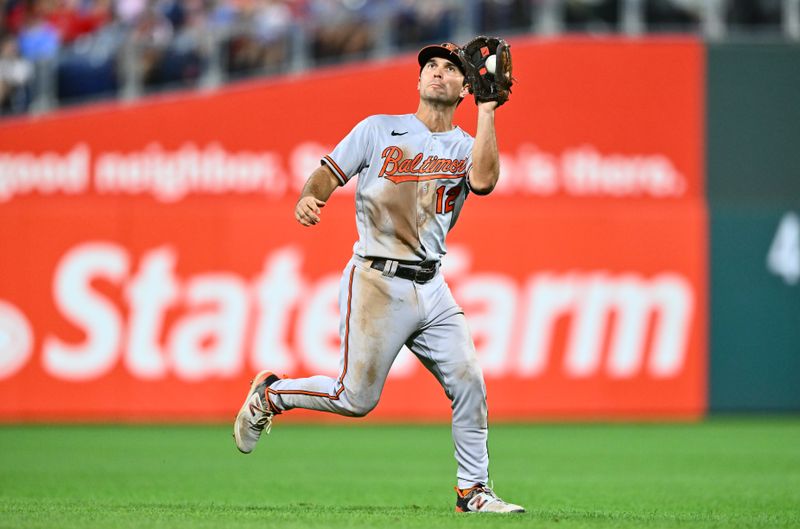 Jul 25, 2023; Philadelphia, Pennsylvania, USA; Baltimore Orioles second baseman Adam Frazier (12) fields a line drive against the Philadelphia Phillies in the seventh inning at Citizens Bank Park. Mandatory Credit: Kyle Ross-USA TODAY Sports