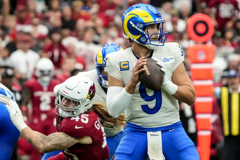 Los Angeles Rams quarterback Matthew Stafford (9) works in the pocket as Arizona Cardinals linebacker Dennis Gardeck (45) defends during the first half of an NFL football game, Sunday, Sept. 15, 2024, in Glendale, Ariz. (AP Photo/Rick Scuteri)