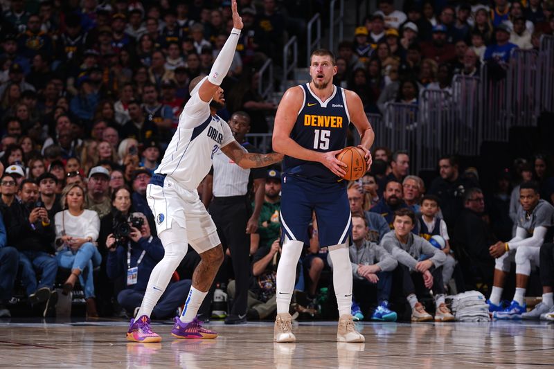 DENVER, CO - NOVEMBER 10: Nikola Jokic #15 of the Denver Nuggets handles the ball during the game against the Dallas Mavericks during a regular season game on November 10, 2024 at Ball Arena in Denver, Colorado. NOTE TO USER: User expressly acknowledges and agrees that, by downloading and/or using this Photograph, user is consenting to the terms and conditions of the Getty Images License Agreement. Mandatory Copyright Notice: Copyright 2024 NBAE (Photo by Bart Young/NBAE via Getty Images)