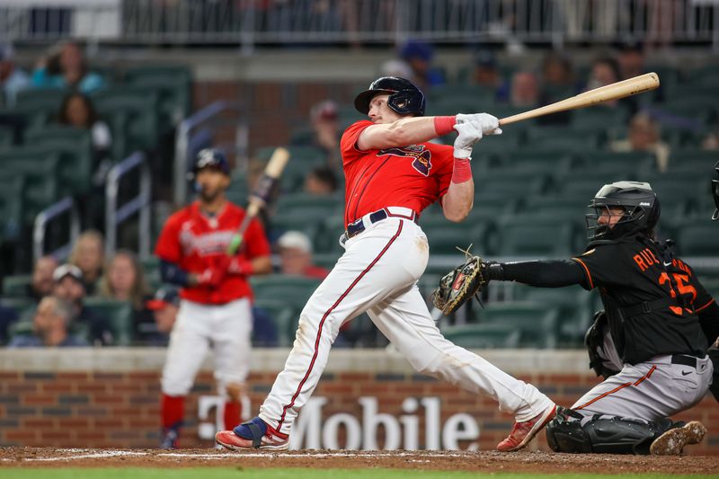 May 5, 2023; Atlanta, Georgia, USA; Atlanta Braves catcher Sean Murphy (12) hits a home run against the Baltimore Orioles in the eighth inning at Truist Park. Mandatory Credit: Brett Davis-USA TODAY Sports